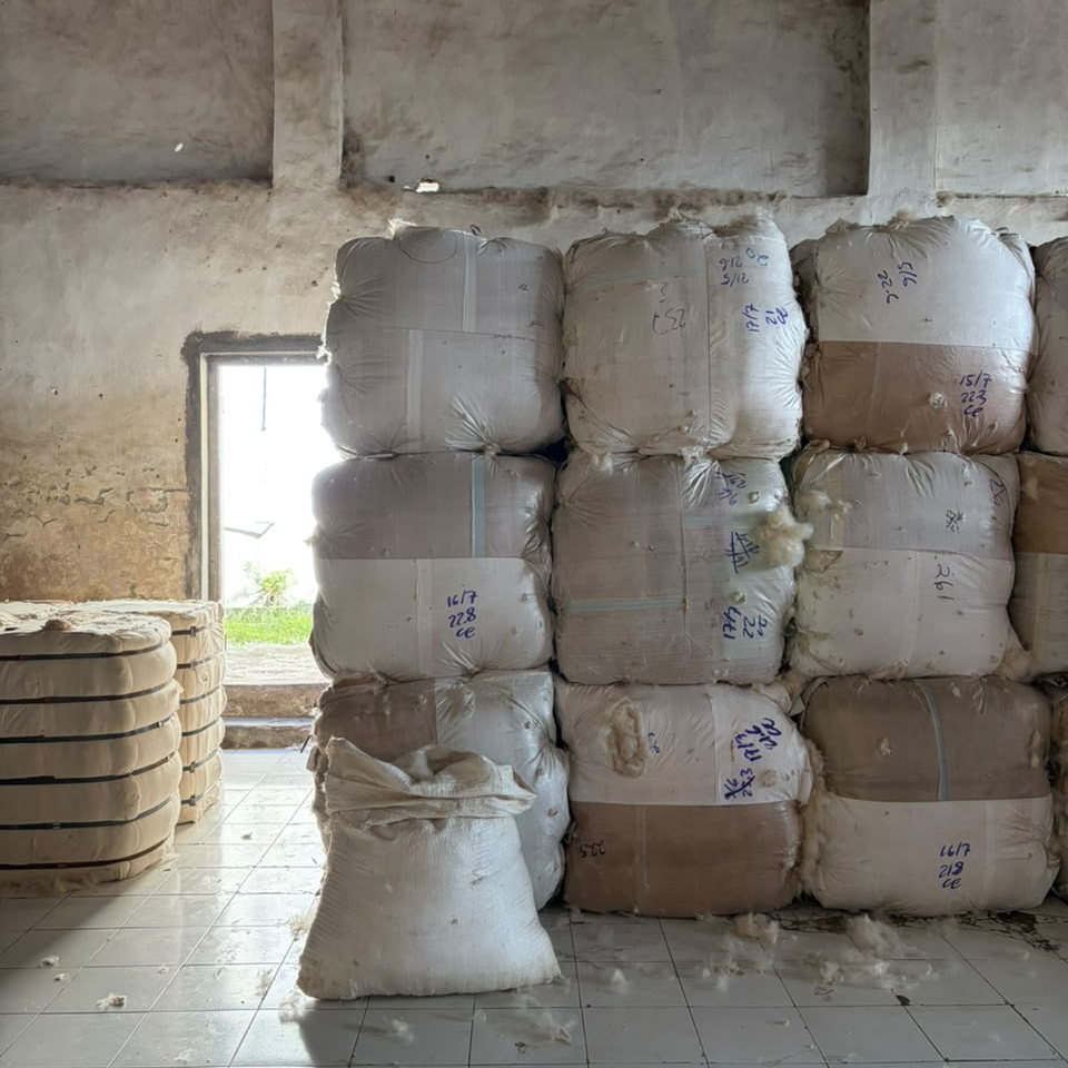 Kapok bales stacked and marked in our East Java warehouse